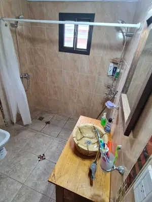 a bathroom with a sink and a counter with a shower at CABAÑA PRIVADA NALÚ in Villa Ciudad Parque