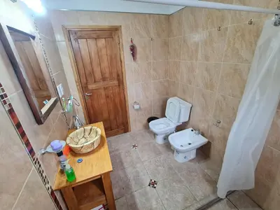 a bathroom with a toilet and a sink at CABAÑA PRIVADA NALÚ in Villa Ciudad Parque