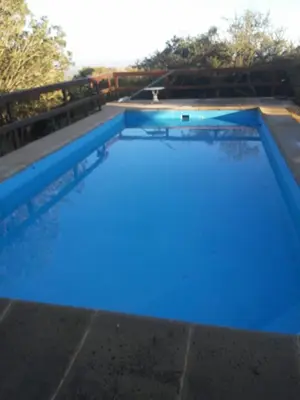 a large swimming pool with blue water at Aldea de Montaña ,La Pichuca in Carpintería