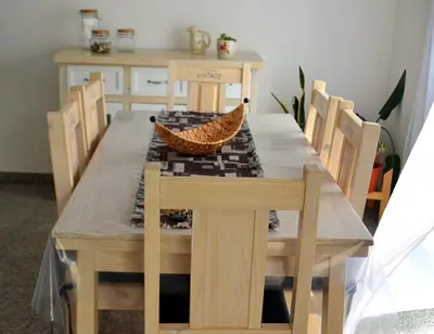 a wooden table with chairs and a dining room at Cholito 2 in Alta Gracia