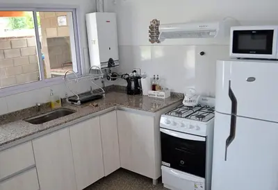 a kitchen with a stove and a white refrigerator at Cholito 2 in Alta Gracia