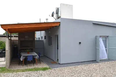 a patio with a table and chairs next to a building at Cholito 2 in Alta Gracia