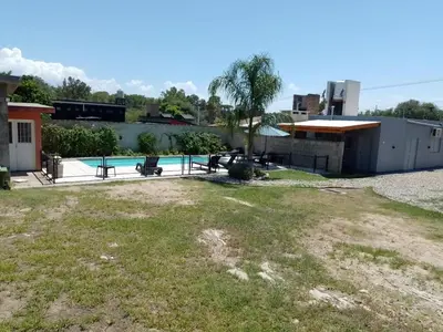 a yard with a pool and a building at Cholito 2 in Alta Gracia