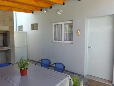 a table and chairs in a patio with a door at Cholito 2 in Alta Gracia