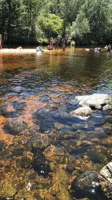 a group of people standing in a river at Olivos del Solar in Villa General Belgrano