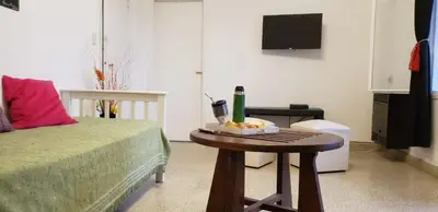 a room with a bed and a table with a bowl of food at Balcones del Cerro Departamento con cochera in Villa Carlos Paz
