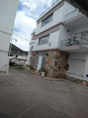 a white apartment building with a balcony at Balcones del Cerro Departamento con cochera in Villa Carlos Paz
