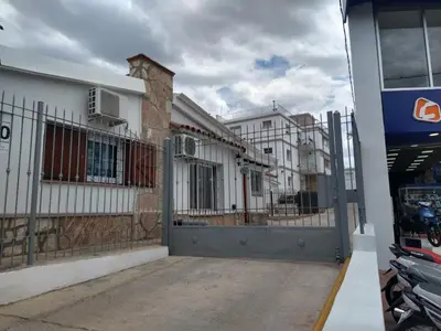 a building with a gate in front of a building at Balcones del Cerro Departamento con cochera in Villa Carlos Paz