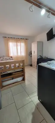 a room with a bedroom with a bed and a counter at Balcones del Cerro Mono ambiente céntrico 2p - camas simples in Villa Carlos Paz