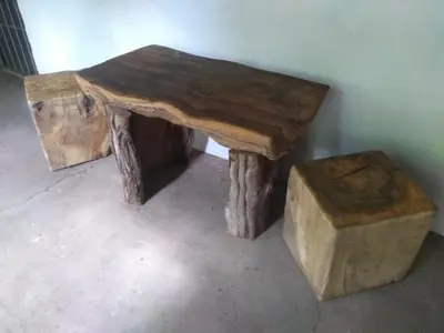 a wooden table with a stool and a table made out of logs at Casa Alma Verde calma in Luyaba