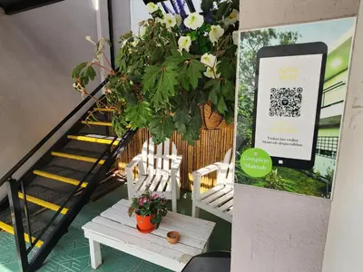 a stairway with two white chairs and a potted plant at Maktub Alta Gracia, Complejo para Turistas in Alta Gracia