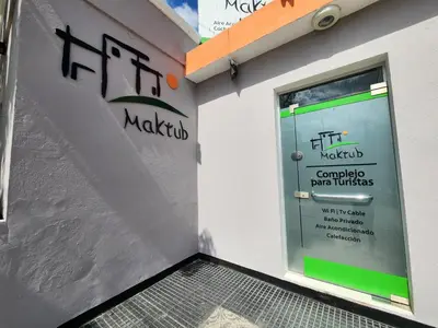 a front door of a building with a sign on it at Maktub Alta Gracia, Complejo para Turistas in Alta Gracia