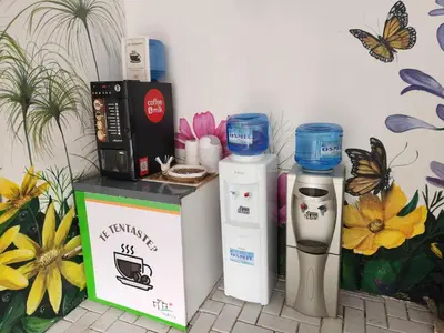 a counter with two coffee machines next to a wall with butterflies at Maktub Alta Gracia, Complejo para Turistas in Alta Gracia