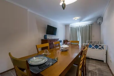 a dining room with a wooden table and chairs at Excelente depto 2 habitaciones en Nueva cordoba By Lofty in Cordoba