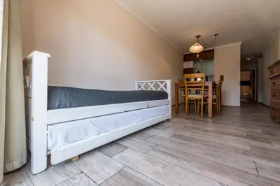 a bedroom with a bed and a dining room at Excelente depto 2 habitaciones en Nueva cordoba By Lofty in Cordoba