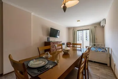 a dining room with a wooden table and chairs at Excelente depto 2 habitaciones en Nueva cordoba By Lofty in Cordoba
