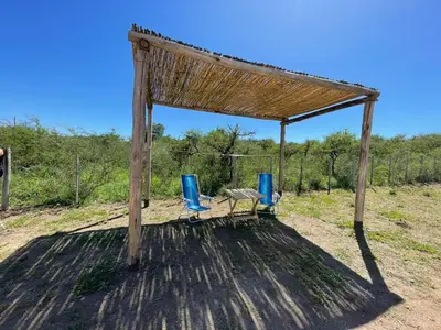 a picnic area with two chairs and a gazebo at El Paraiso - Jose de La Quintana in José de la Quintana
