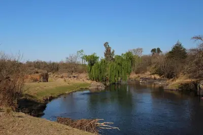 a river with a bridge in the middle at El Paraiso - Jose de La Quintana in José de la Quintana