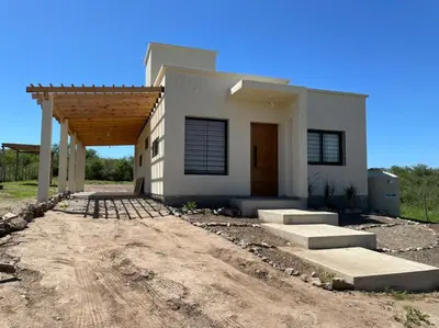 a white house with a porch and a driveway at El Paraiso - Jose de La Quintana in José de la Quintana