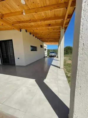 a porch with a wooden ceiling and a car garage at El Paraiso - Jose de La Quintana in José de la Quintana