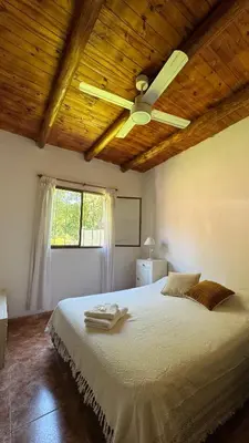 a bedroom with a bed with a ceiling fan at LA FACUNDA in San Francisco del Monte de Oro