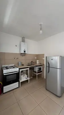 a kitchen with a stove and a refrigerator at LA FACUNDA in San Francisco del Monte de Oro