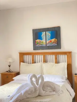 a bed with white towels on top of it at Posada D`Lua in Villa Carlos Paz
