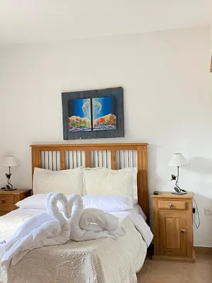 a bedroom with a bed with a towel on it at Posada D`Lua in Villa Carlos Paz