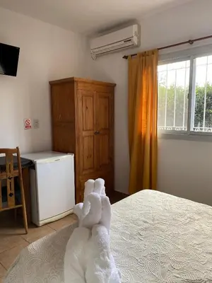 a bedroom with a bed with a stuffed animal laying on it at Posada D`Lua in Villa Carlos Paz
