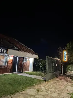 a gate in front of a house at night at Posada D`Lua in Villa Carlos Paz