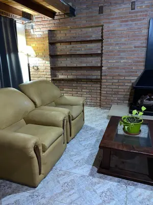 a living room with a couch and a coffee table at Posada D`Lua in Villa Carlos Paz