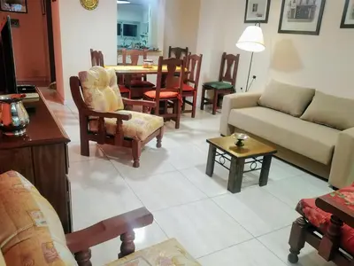 a living room with a couch and chairs and a table at Amplio departamento en Nueva Cordoba - Bv Chacabuco in Cordoba