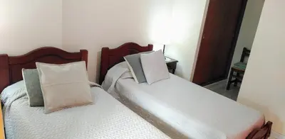 a bedroom with two beds with pillows at Amplio departamento en Nueva Cordoba - Bv Chacabuco in Cordoba