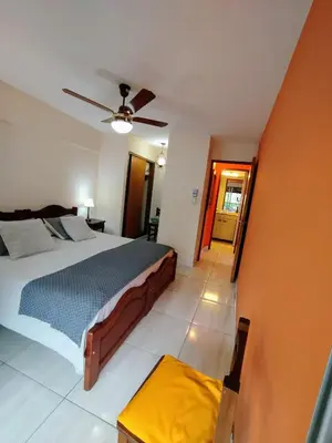 a bedroom with a bed and a ceiling fan at Amplio departamento en Nueva Cordoba - Bv Chacabuco in Cordoba