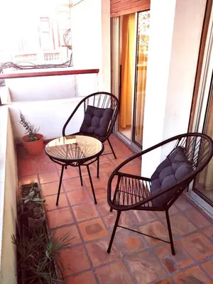 two chairs and a table on a patio at Amplio departamento en Nueva Cordoba - Bv Chacabuco in Cordoba