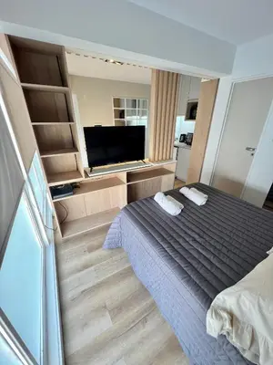 a bedroom with a bed and a flat screen tv at Estudio - apartamento cómodo y acogedor SS1 in Cordoba