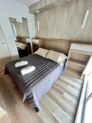 a bedroom with a bed with two pillows on it at Estudio - apartamento cómodo y acogedor SS1 in Cordoba