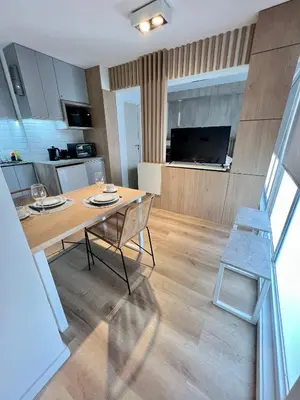 a kitchen and living room with a table and chairs at Estudio - apartamento cómodo y acogedor SS1 in Cordoba