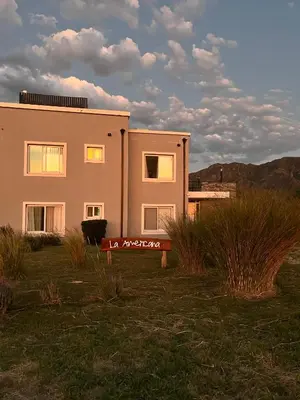 a house with a sign in front of it at La Americana, casa entre sierras in Luján