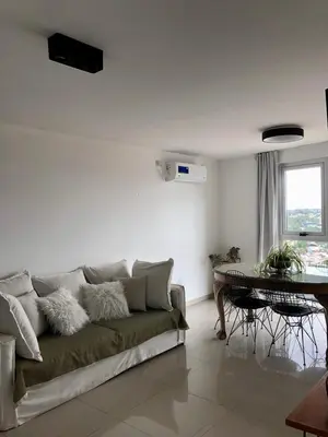 a living room with a couch and a table at Güemes Premium, 2 dorm con Vista a las Sierras ALOHA #2 in Cordoba