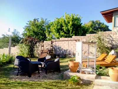 a group of chairs sitting in a yard at ENCANTO SERRANO in Villa Carlos Paz