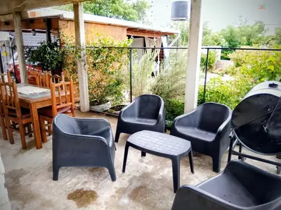 a group of chairs and tables on a patio at ENCANTO SERRANO in Villa Carlos Paz