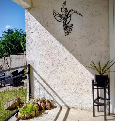 a bird stenciled on the side of a wall at ENCANTO SERRANO in Villa Carlos Paz