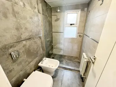 a bathroom with a toilet and a sink at HABITAT Departamentos in Villa Carlos Paz