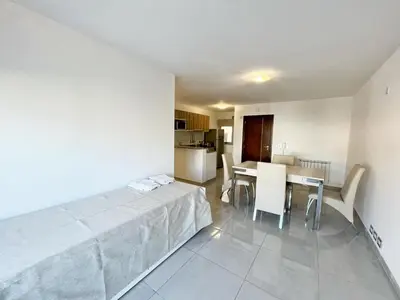 a kitchen and dining room with a table and chairs at HABITAT Departamentos in Villa Carlos Paz