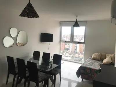 a living room with a table and chairs and a bed at Vista Privilegiada in Cordoba