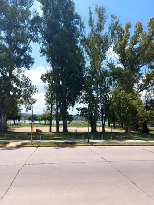 an empty parking lot with trees in a park at Castillo Del Lago - Carlos Paz - dep17 in Villa Carlos Paz