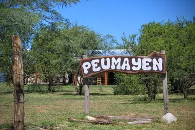 a sign for a pomgrass sign in a field at Peumayen Cabañas in Villa de Las Rosas