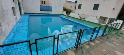a large blue swimming pool next to a building at Castillo Del Lago - Carlos Paz - D16 in Villa Carlos Paz