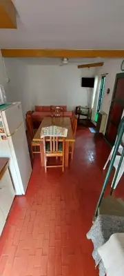 a living room with a table and a couch at Castillo Del Lago - Carlos Paz - D16 in Villa Carlos Paz